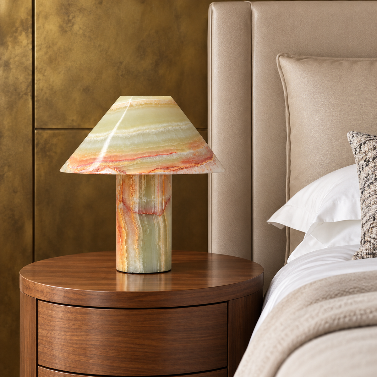 Banded stone table lamp with a conical shade, placed in a bedside setting