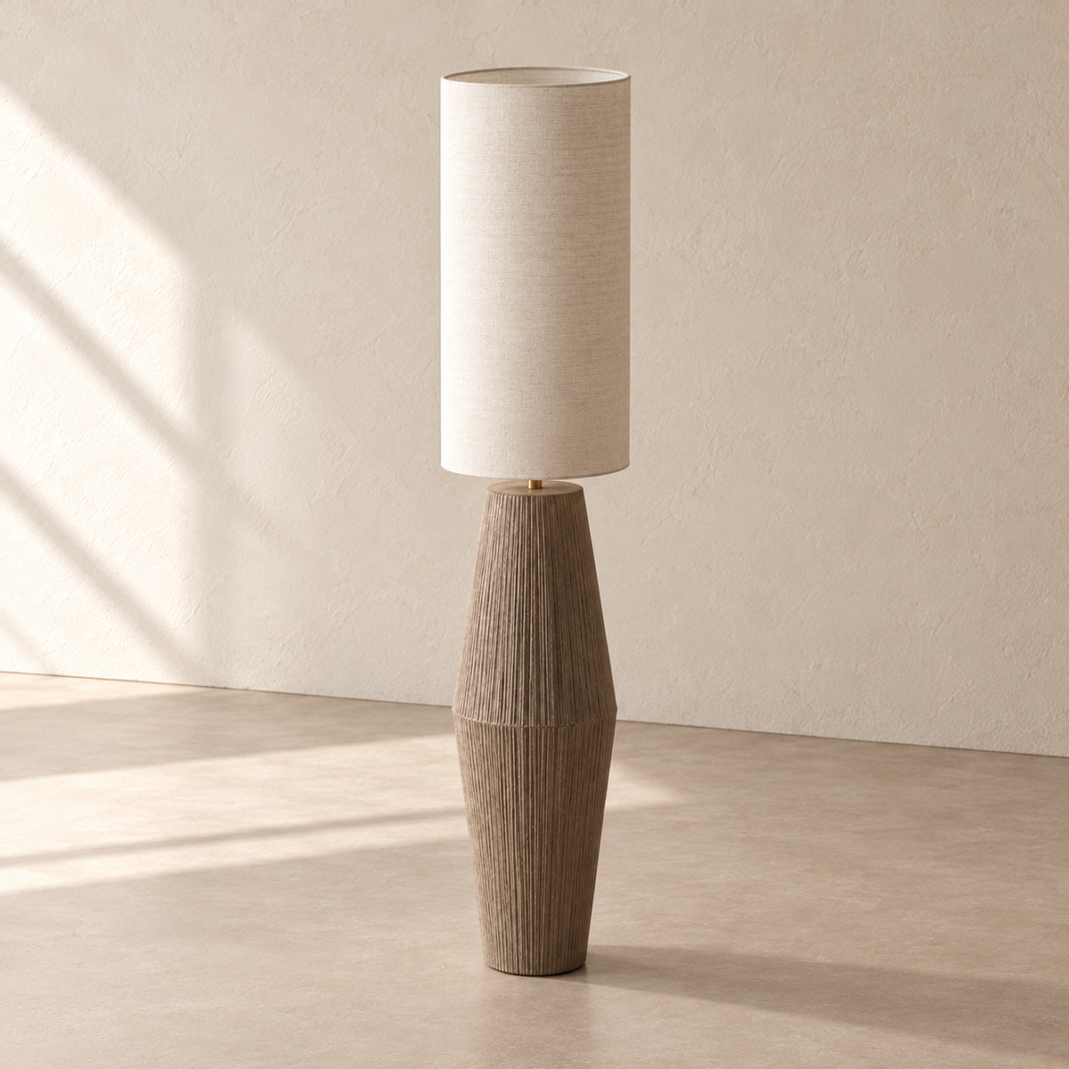 Angled view of Palestrina’s linen shade, short brass neck and tapered textured base.