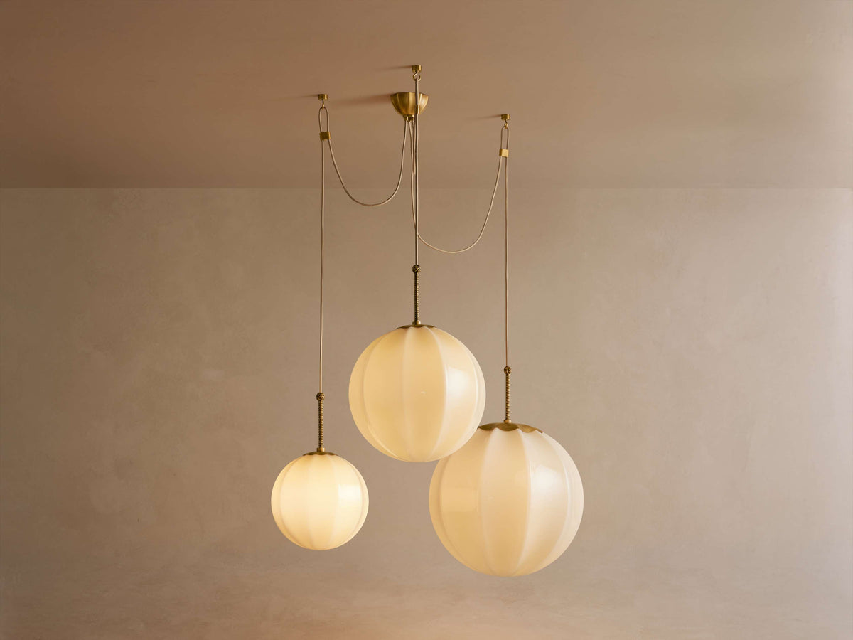 Ribbed cream glass cluster chandelier, wider spread of the three globes, lit