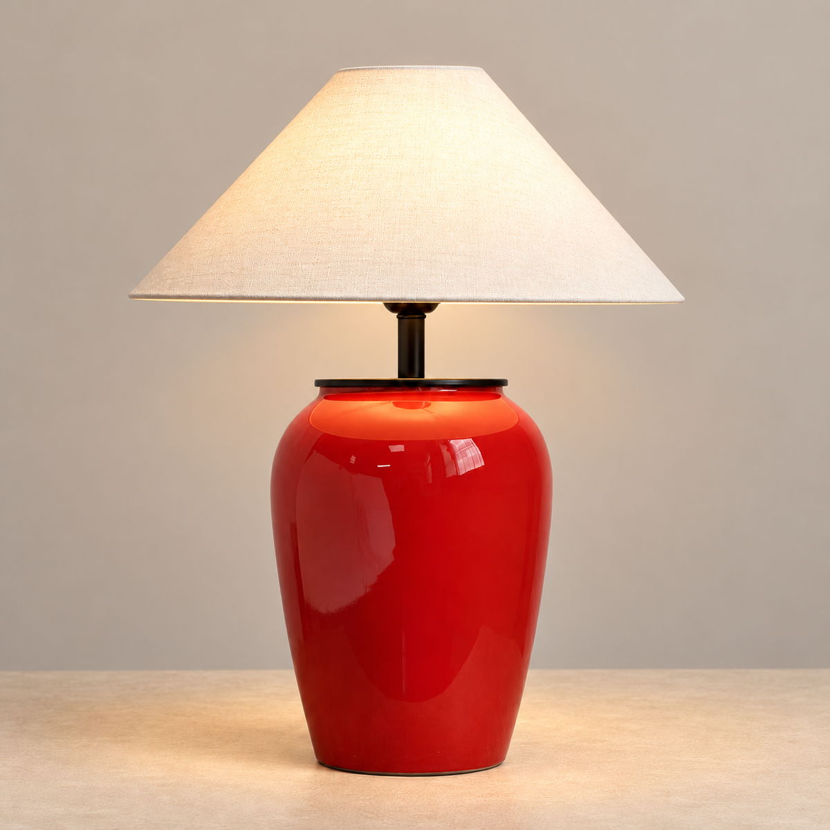 Salmeri red ceramic table lamp illuminated on a beige background