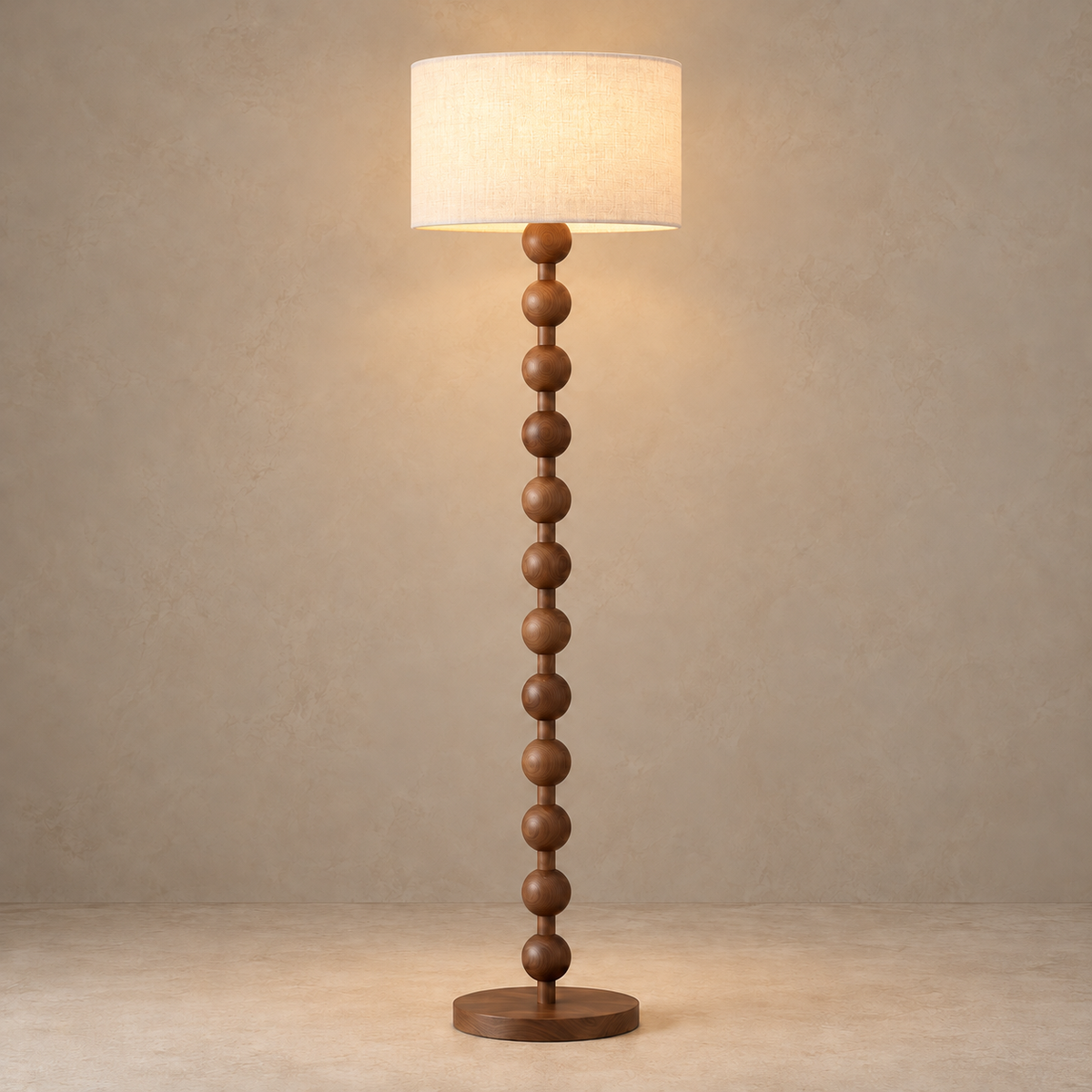 Sirmione walnut floor lamp lit through its white linen shade.