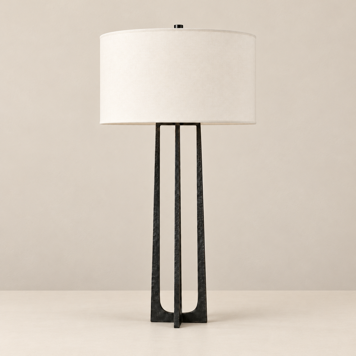 Tall Black Hammered Copper Table Lamp, switched off, on a beige background.