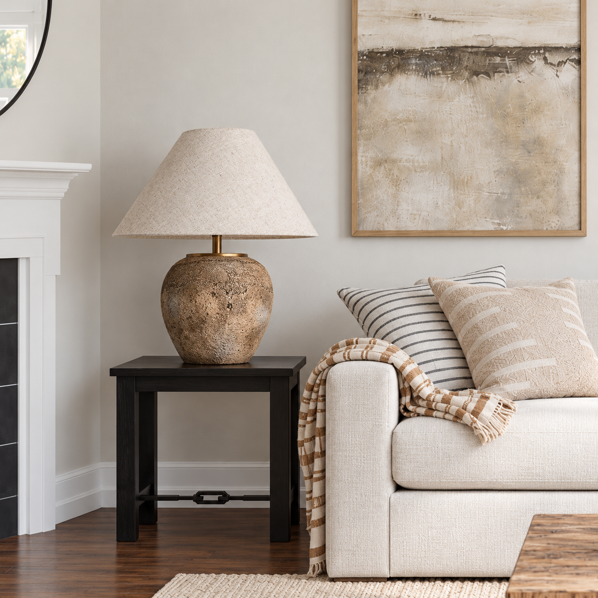 Taupe ceramic lamp beside a cream living room sofa.