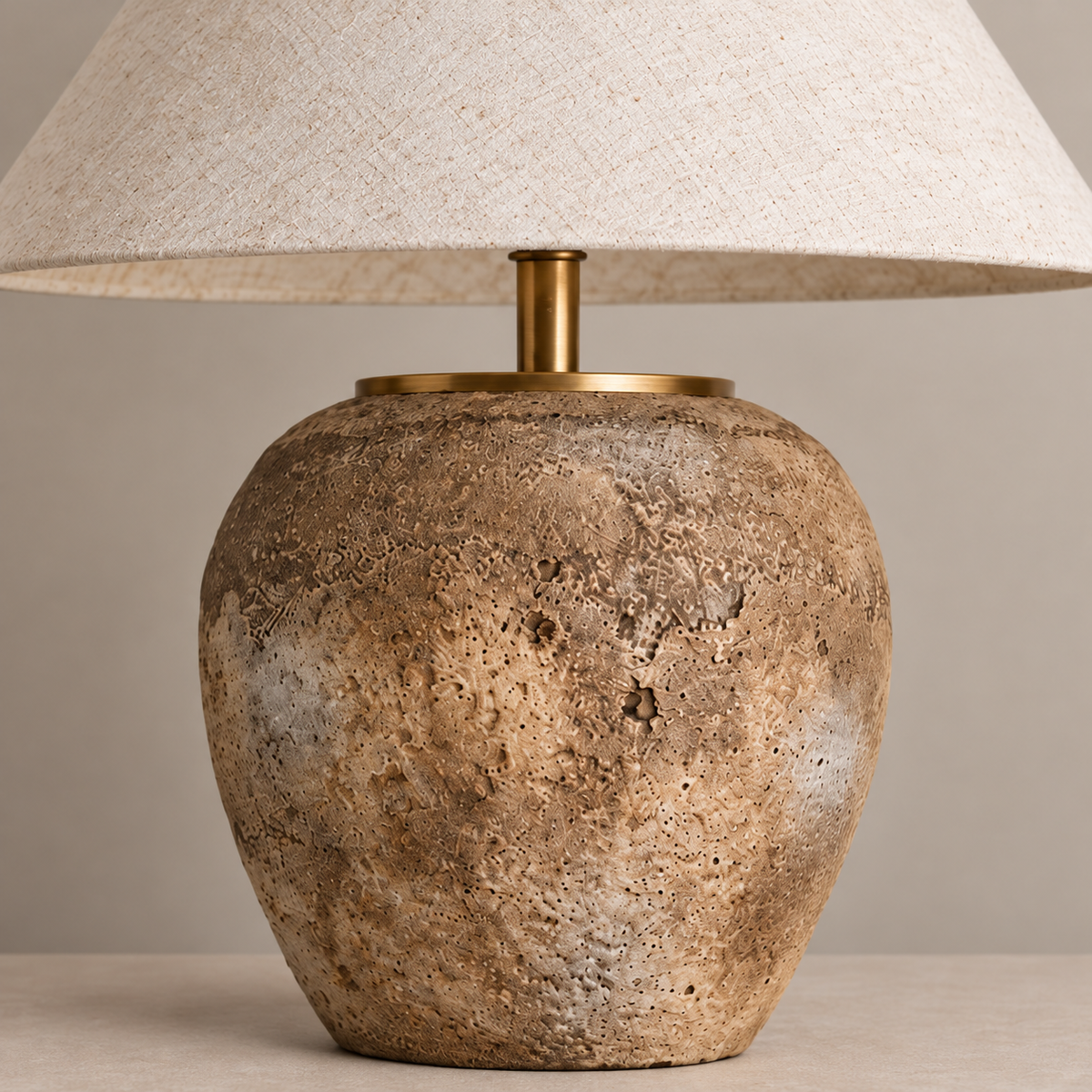 Close-up of textured ceramic glaze and the brass collar.