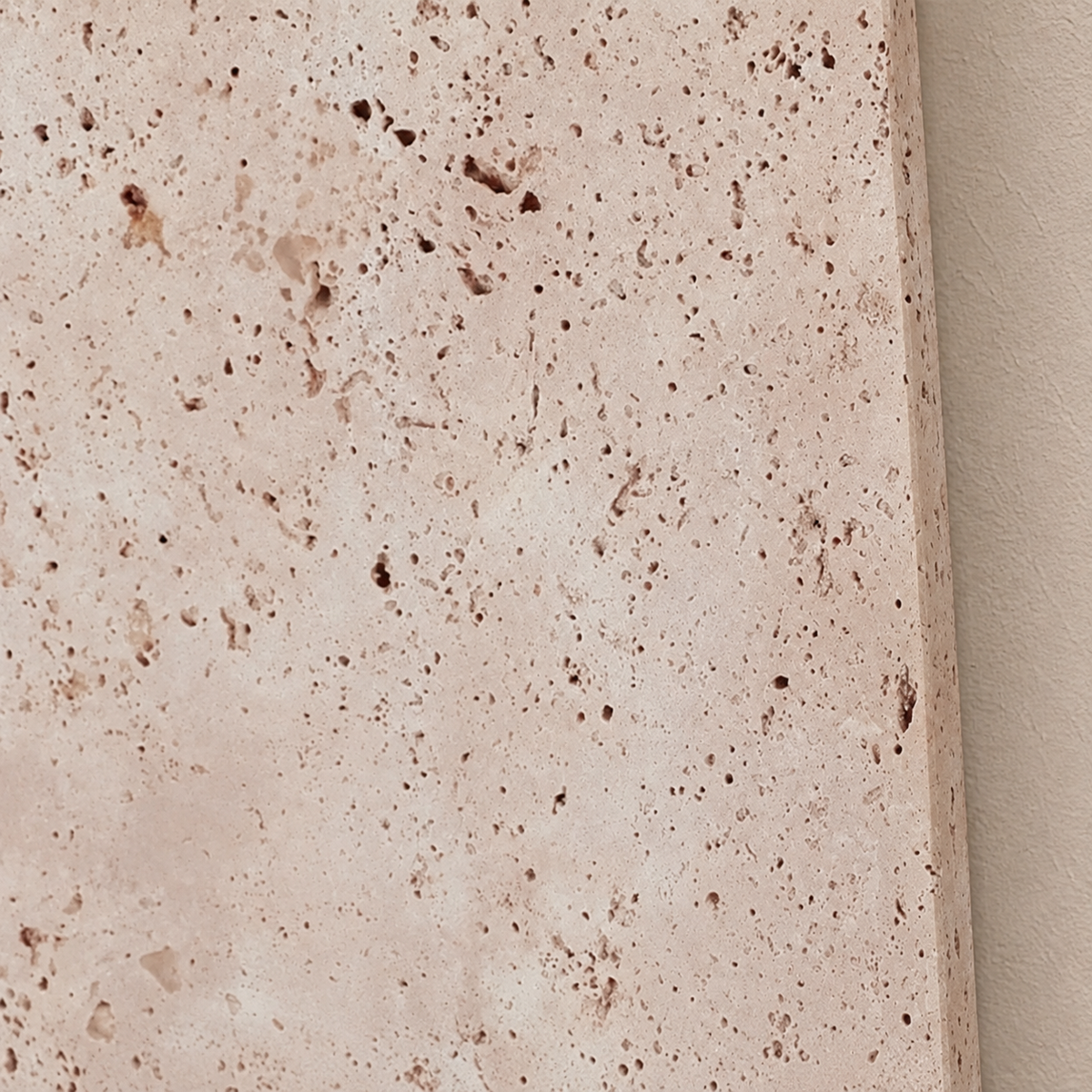 Close-up of the flat travertine panel and its natural porous surface.