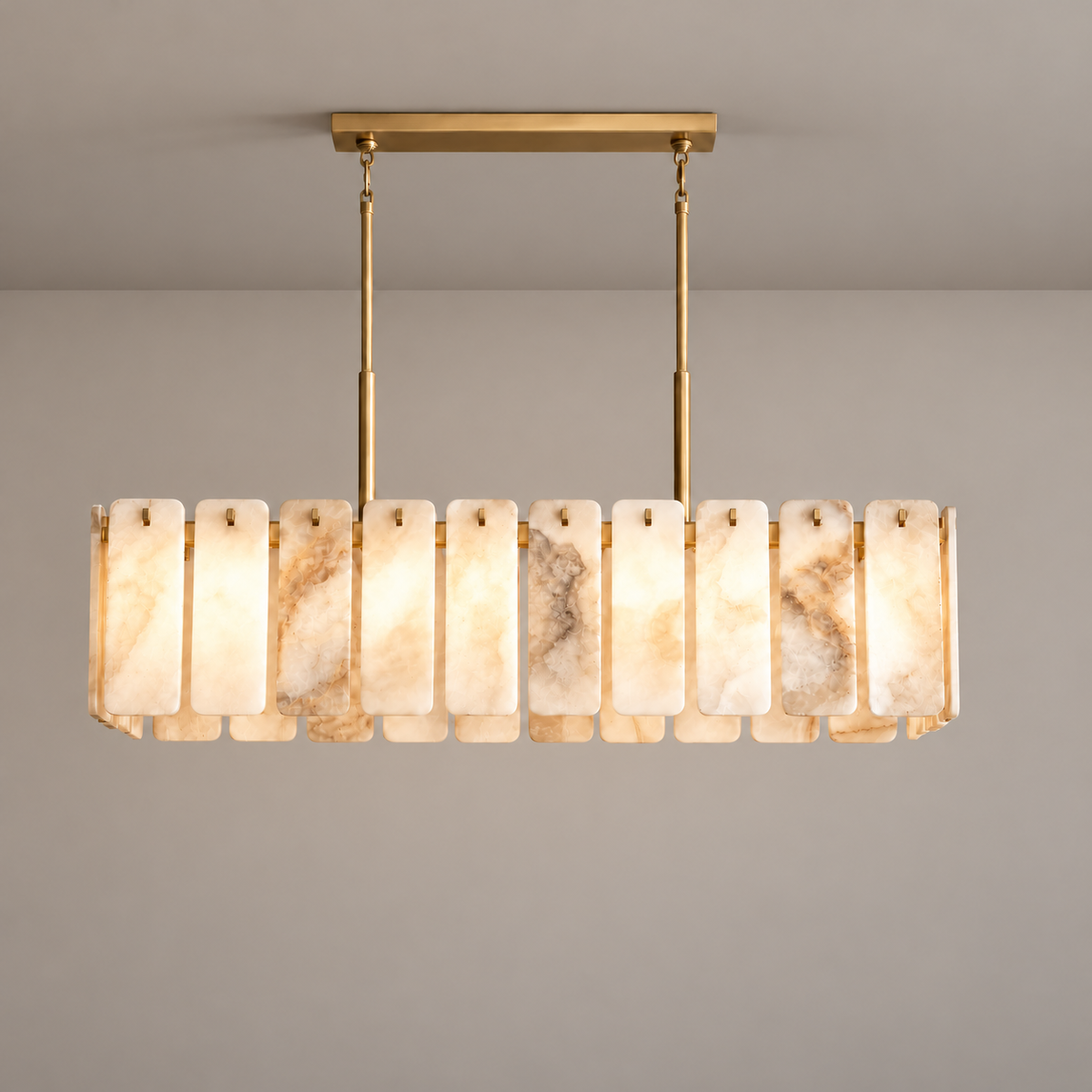 Voltesio brass chandelier illuminated, with natural cloudy alabaster panels.
