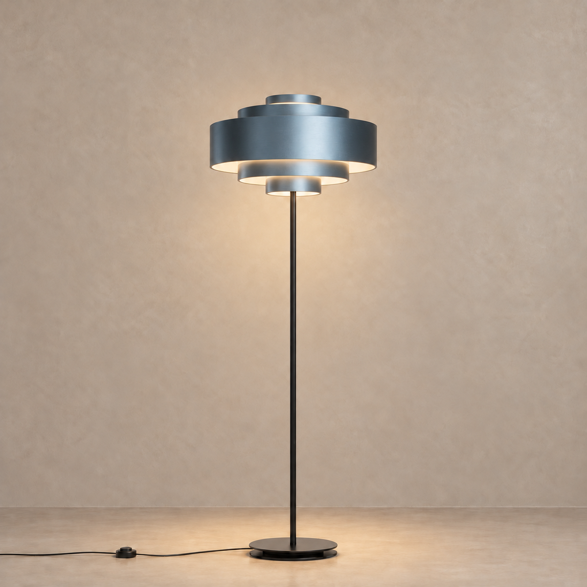 Blue CL85070M floor lamp with warm light beneath its concentric shade tiers.