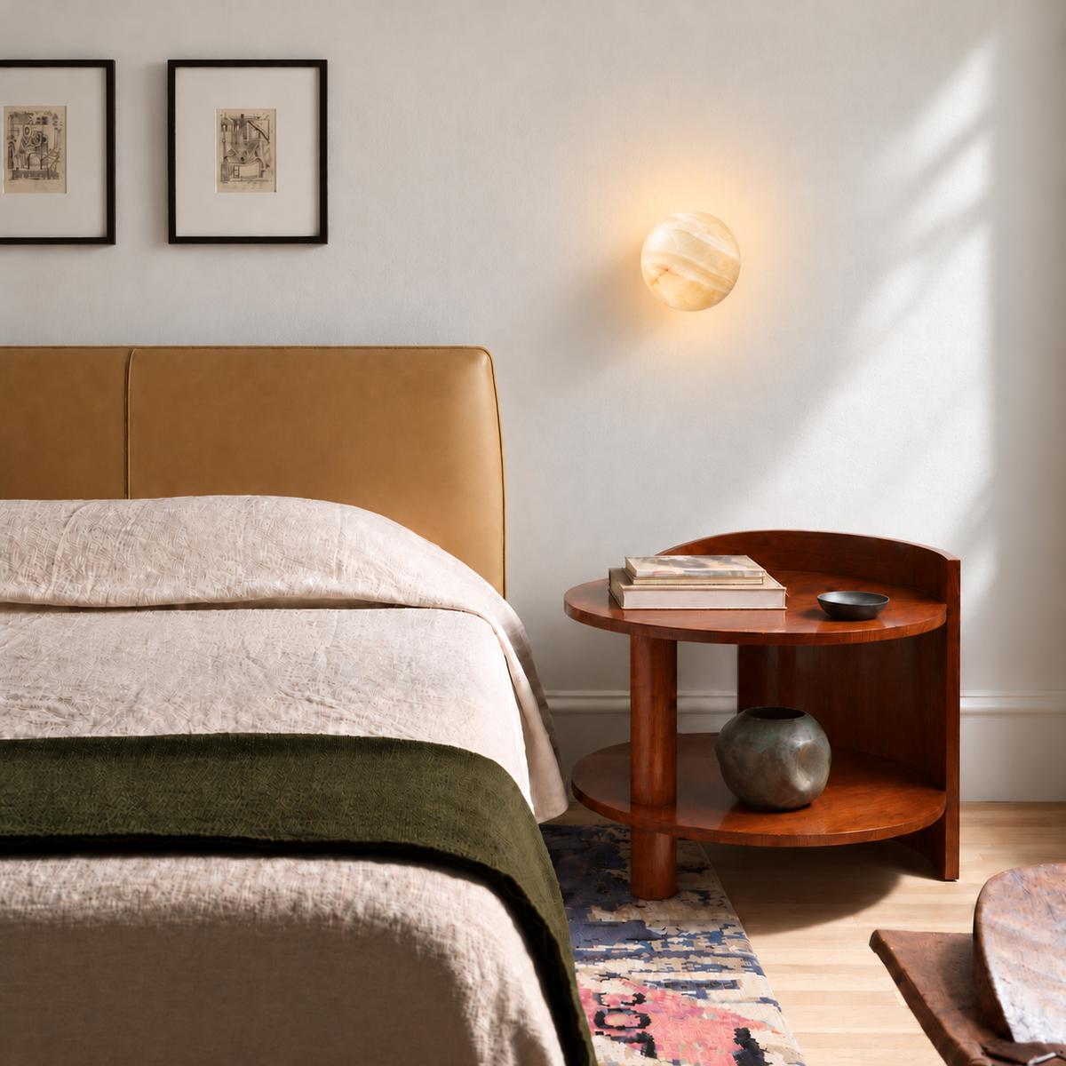 Front-facing Totem honey onyx globe sconce above a wooden bedside table.