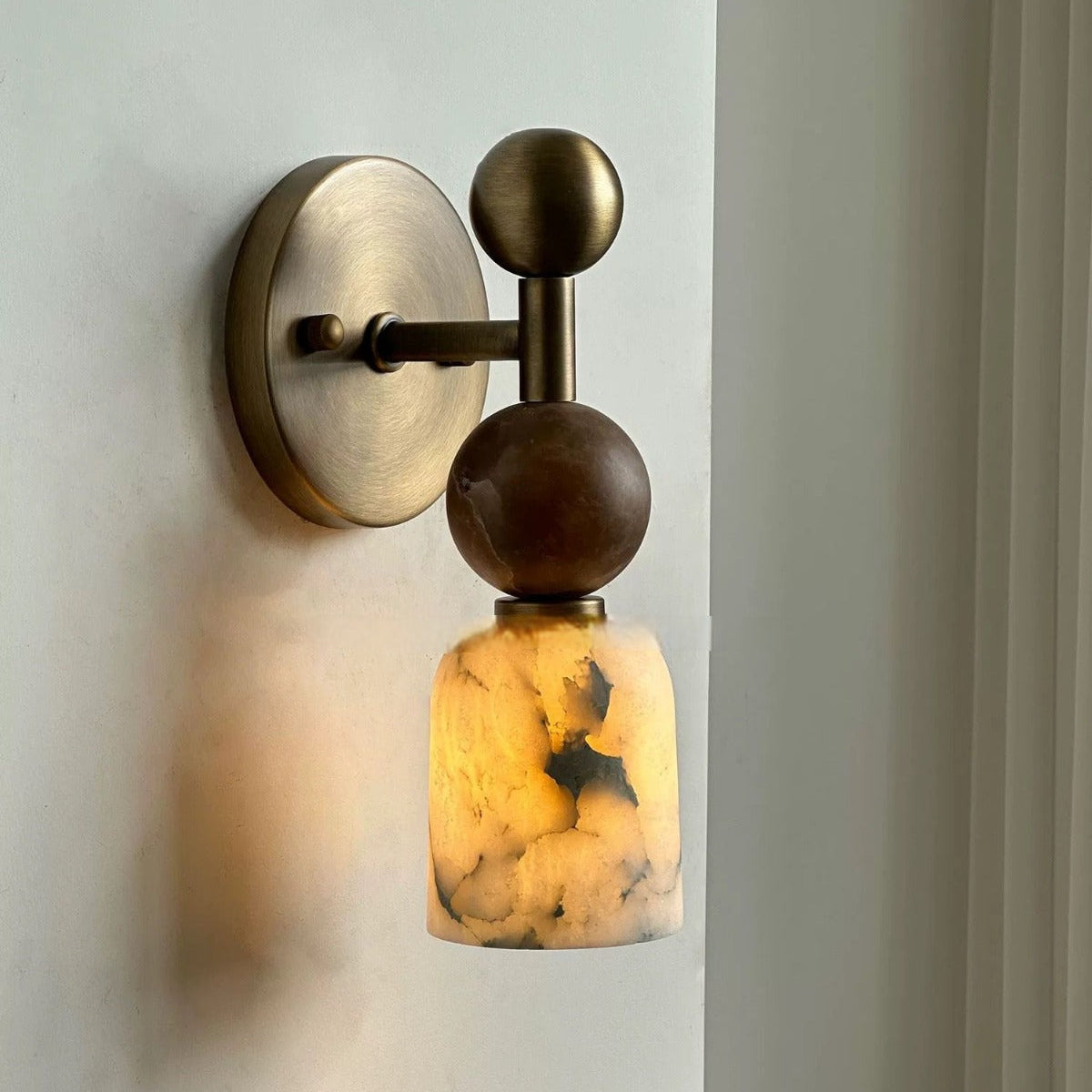 Wall-mounted light fixture with a decorative design on a neutral background