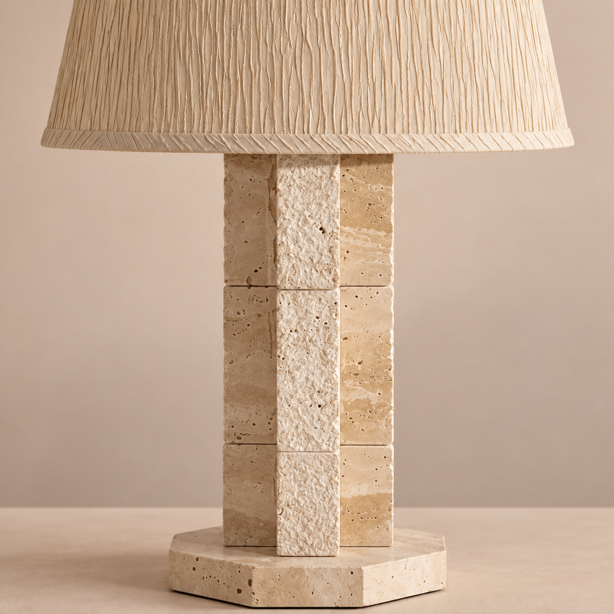 Close-up of travertine blocks and crinkled shade fabric.