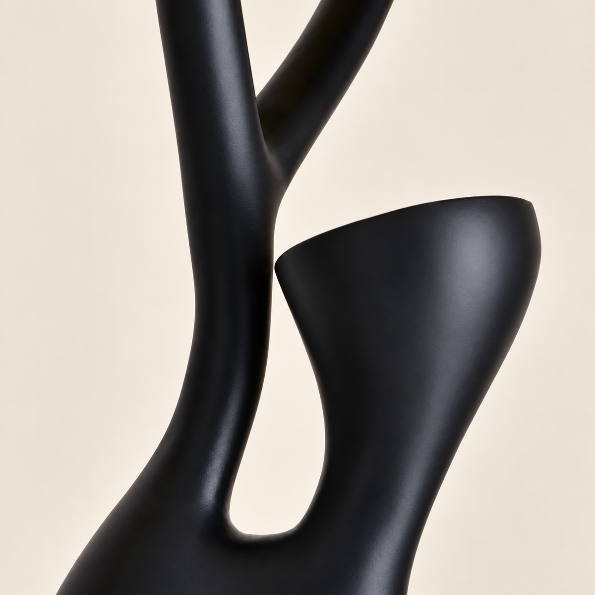 Detail of the Tree floor lamp's curved black resin branch and upward-facing cup.