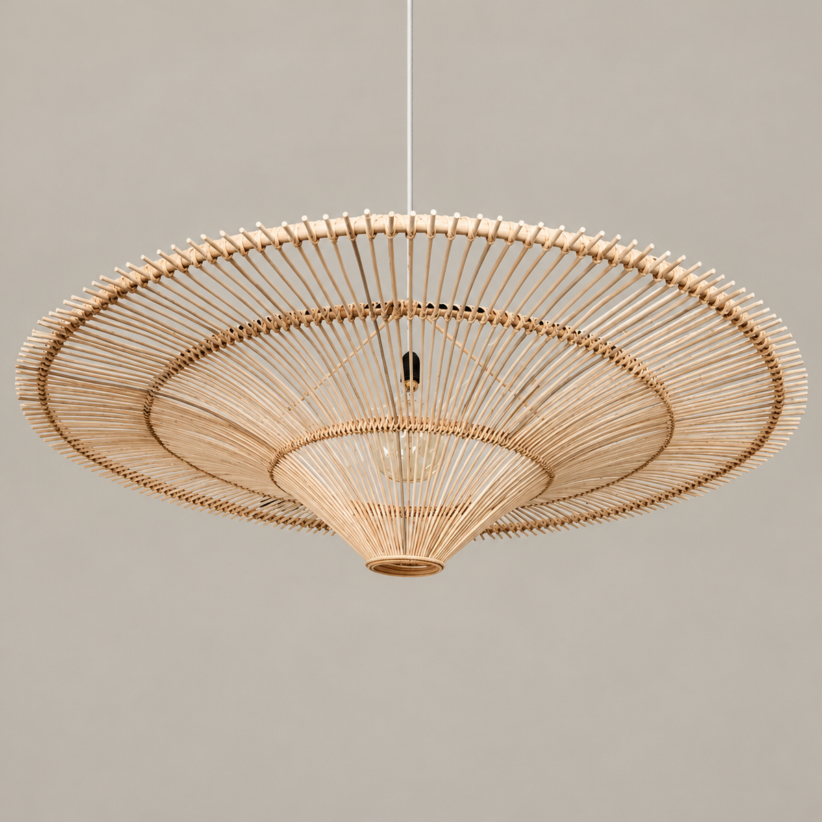Beige CLWIC wicker pendant with its shallow curved shade, unlit