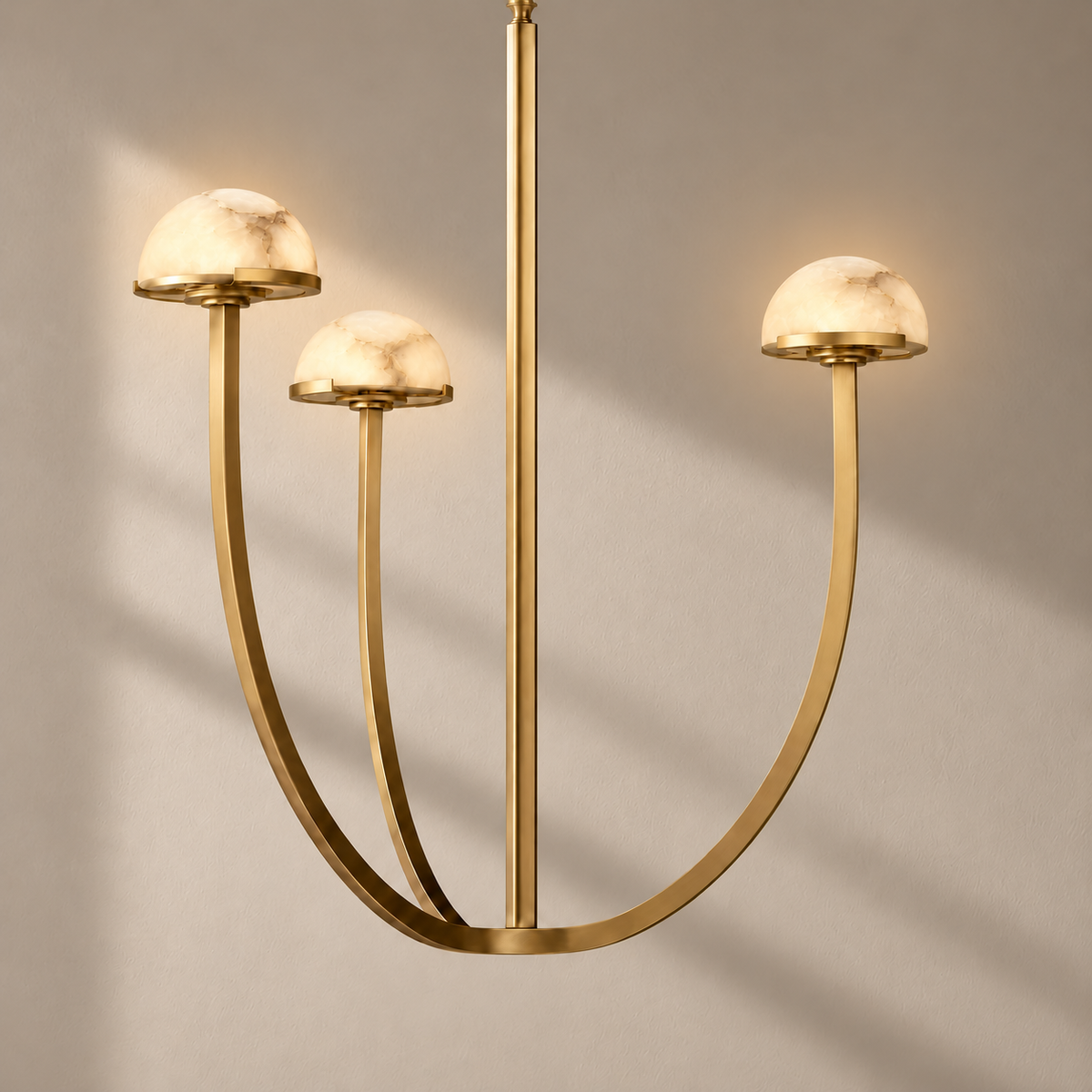 Three-light brass 3 Arch chandelier illuminated, showing natural alabaster mineral clouds.