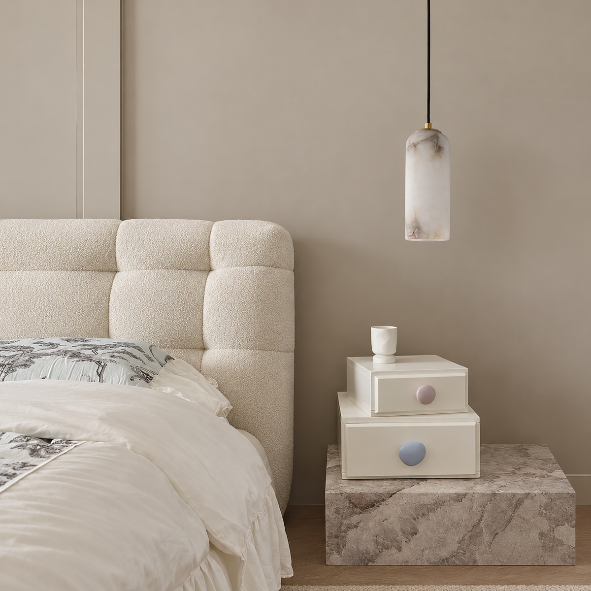 Alabaster column pendant beside an upholstered bed and stone bedside table.