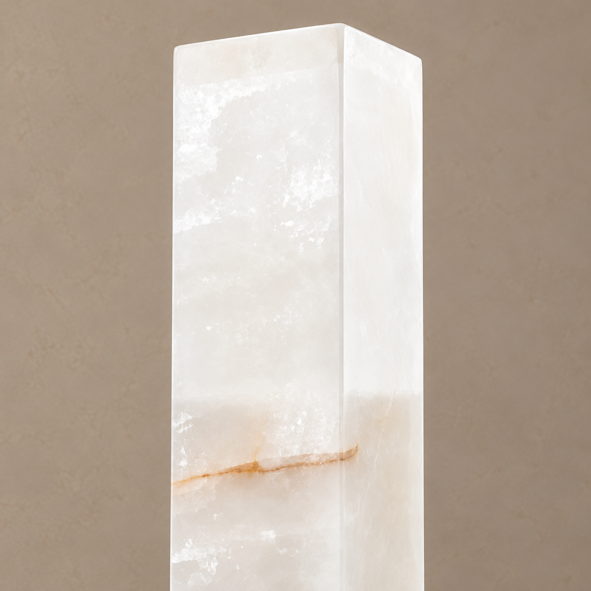 Close view of the square alabaster column, cloudy stone and a sparse tan mineral band.