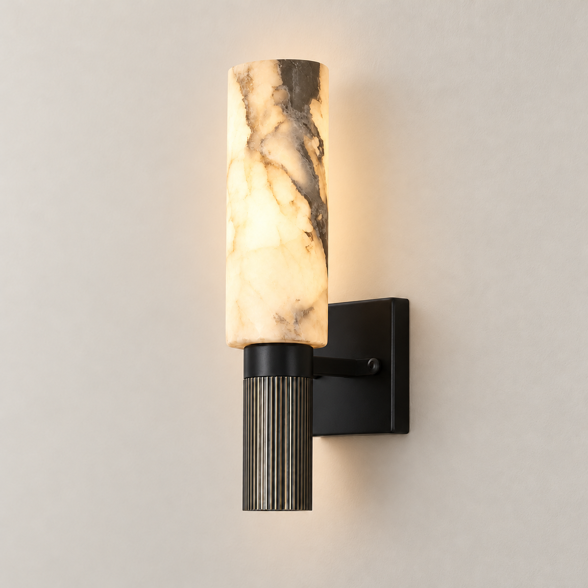 Alabaster cylinder sconce illuminated, showing its natural mineral pattern.