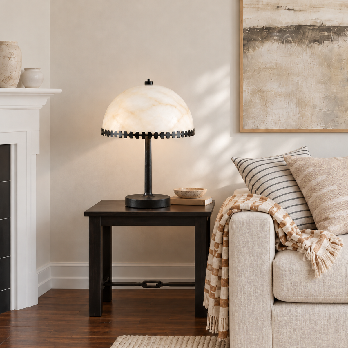 Alabaster dome table lamp with a black metal toothed rim, placed in a living room setting