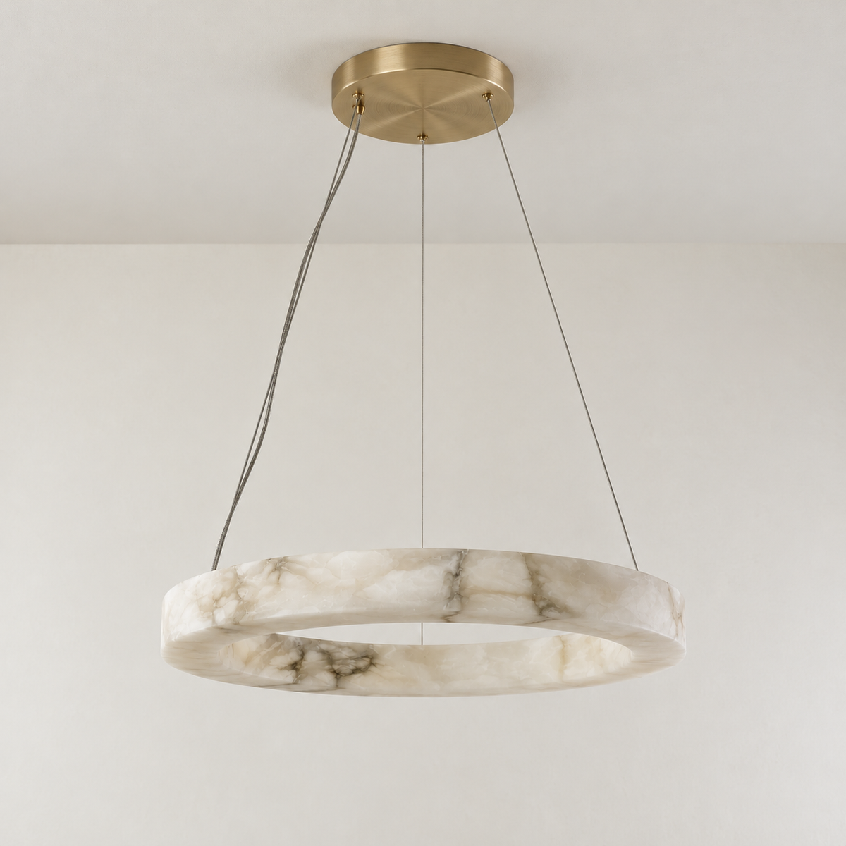 Anello alabaster ring chandelier unlit with brass canopy and fine suspension cables.