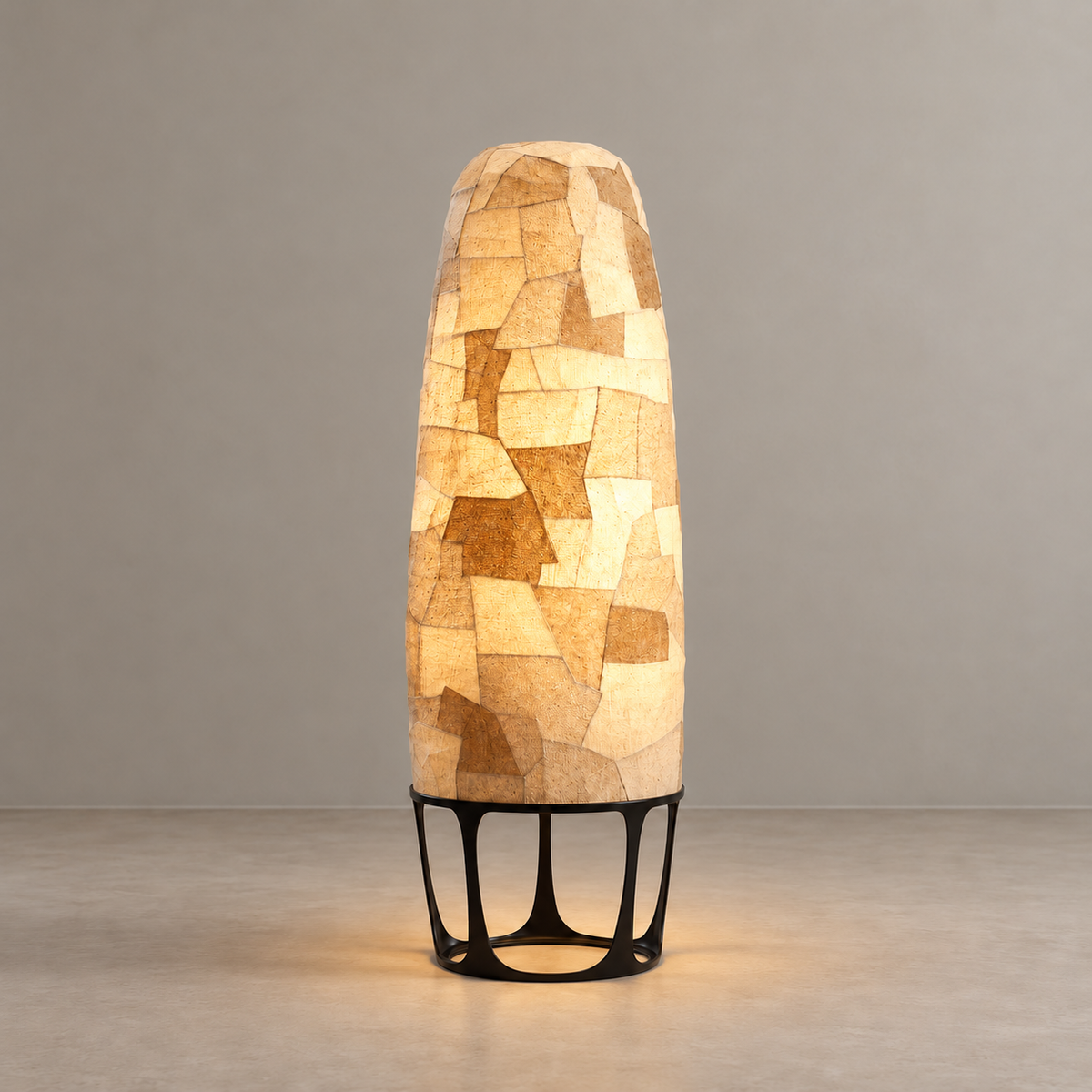 Illuminated Appia floor lamp with light filtering through its layered textile surface.