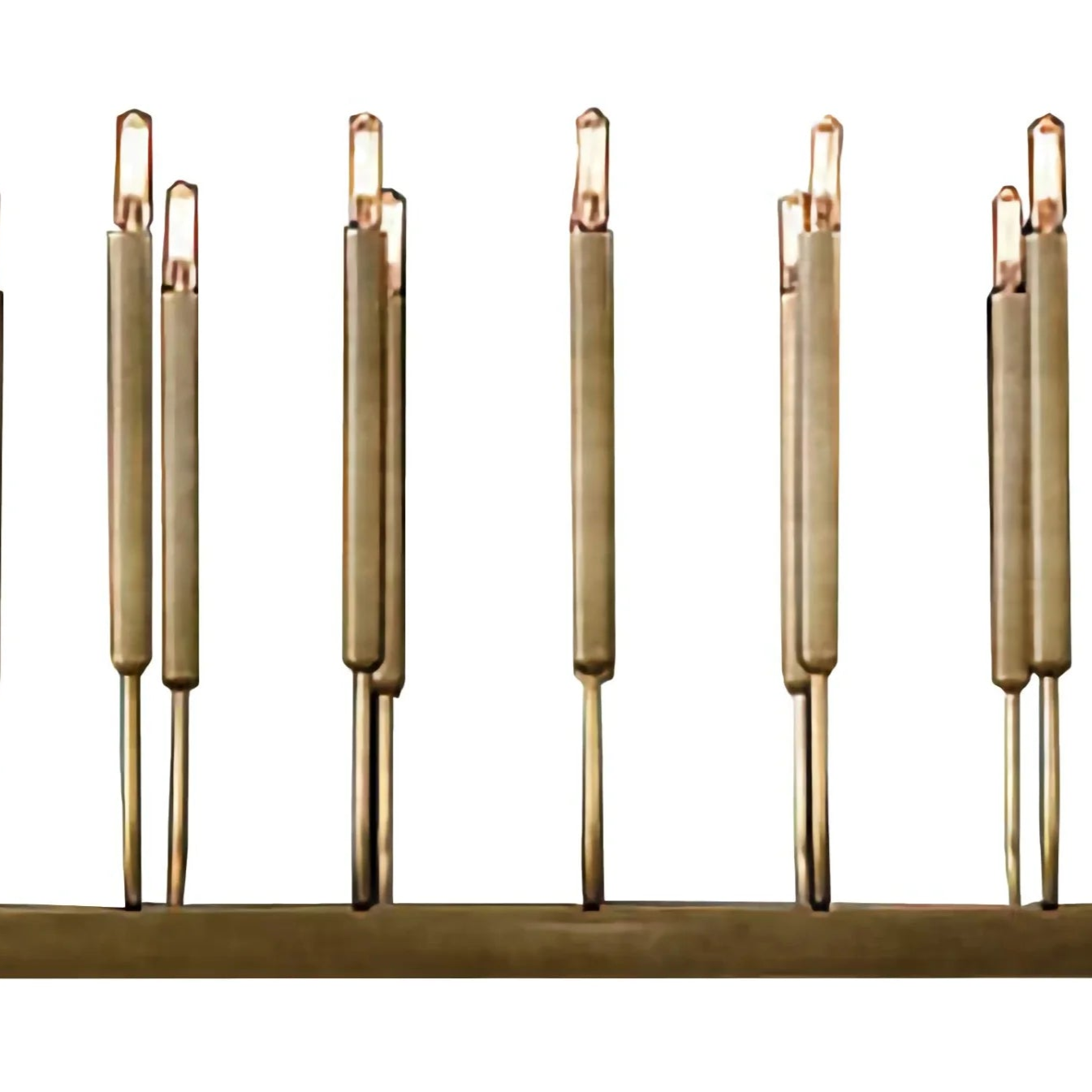 Set of gold-colored candles on a white background