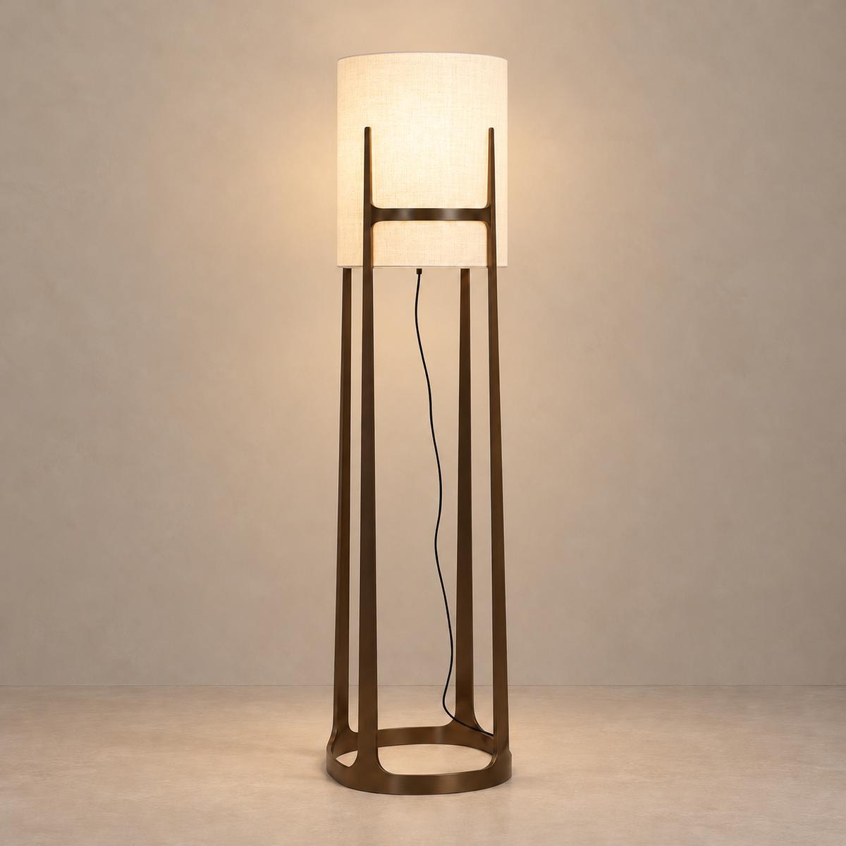 Atelier CLATL162 floor lamp illuminated, with the linen shade glowing inside its open iron frame.