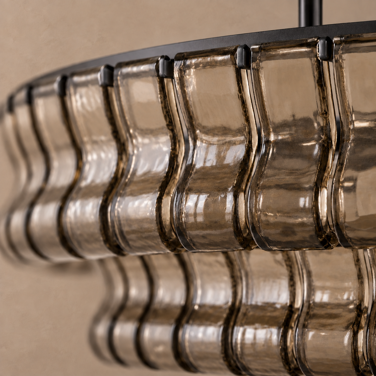 Close-up of the Bellatrix Long chandelier’s thick smoky brown glass and rounded S-shaped curves.