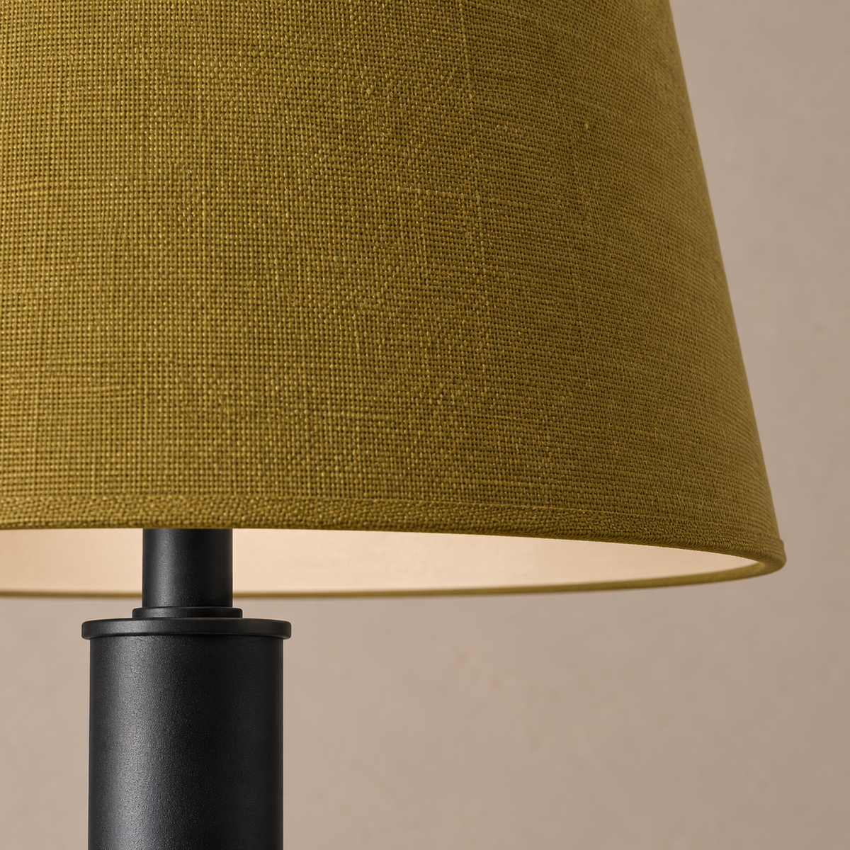 Close-up of the olive shade's woven fabric and bound rim above the black stainless steel stem.