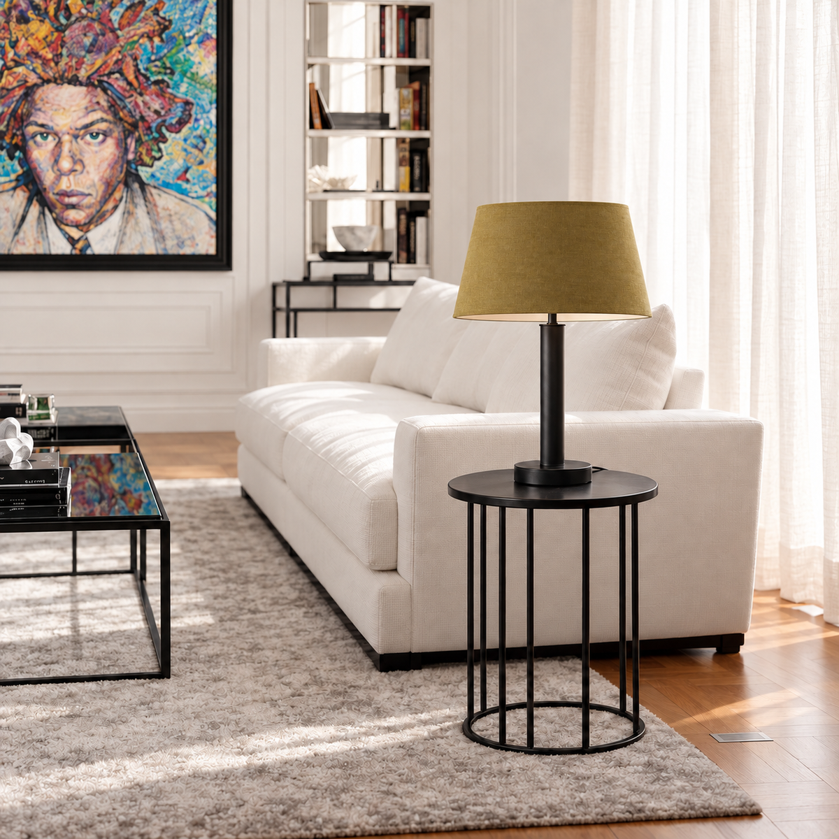 Matte black stainless steel table lamp with an olive tapered fabric shade on a side table beside a cream sofa.