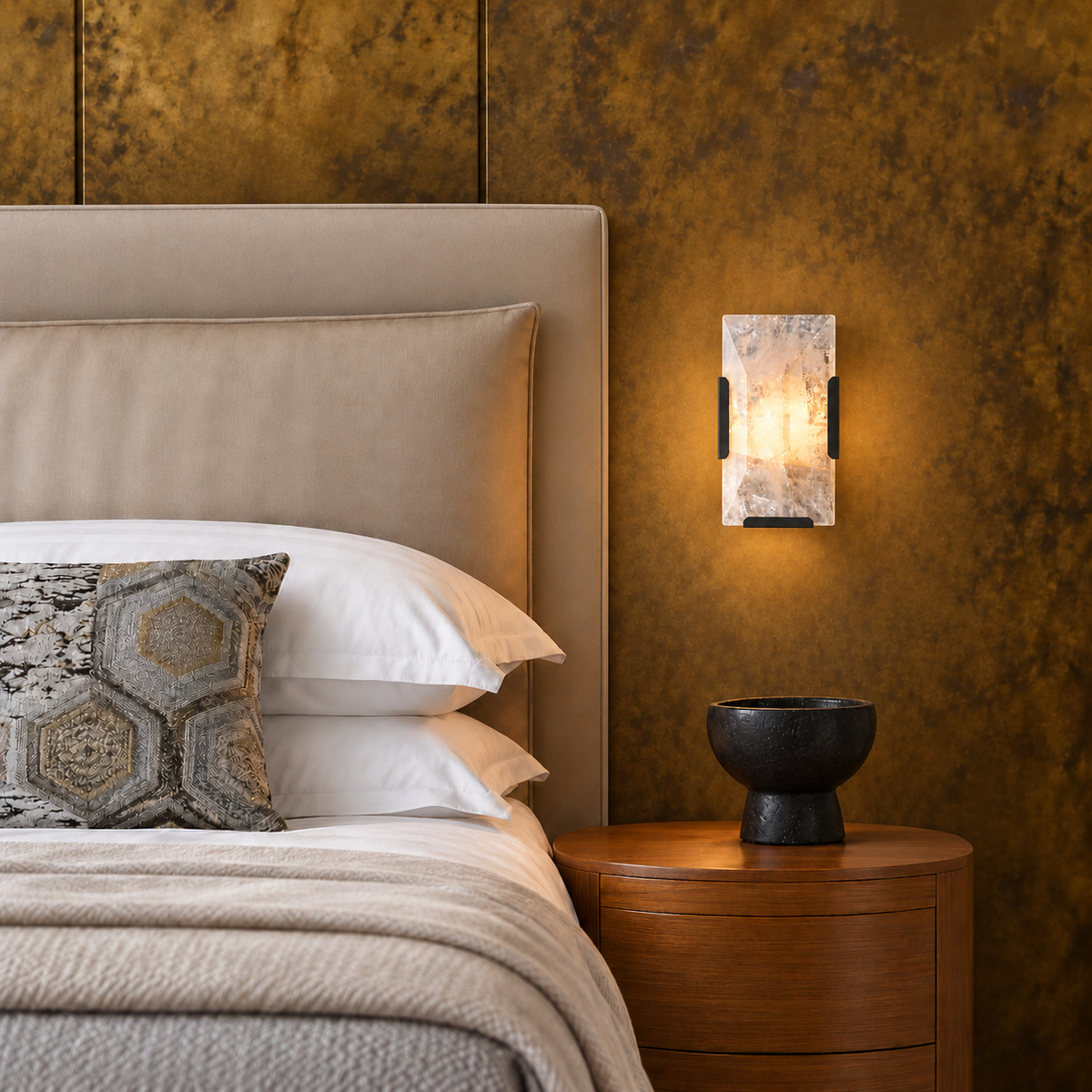 Crystal wall sconce with black fittings, shown straight on beside a bed.
