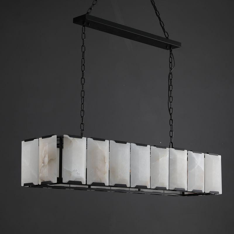 Black steel-cage linear chandelier with hand-cut alabaster panels over a loft dining table
