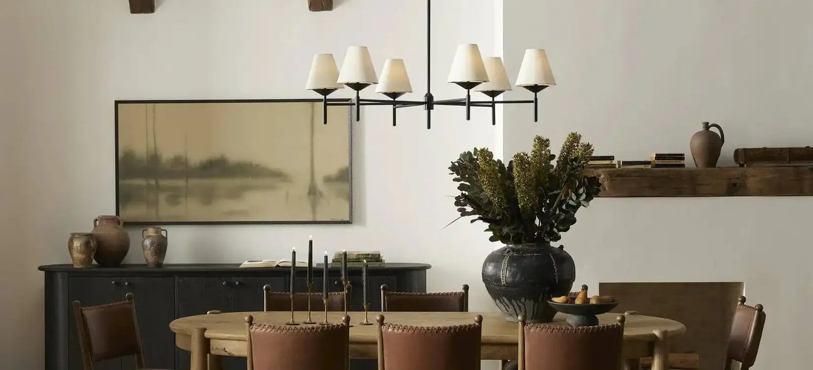 Black metal chandelier with cream-colored lampshades