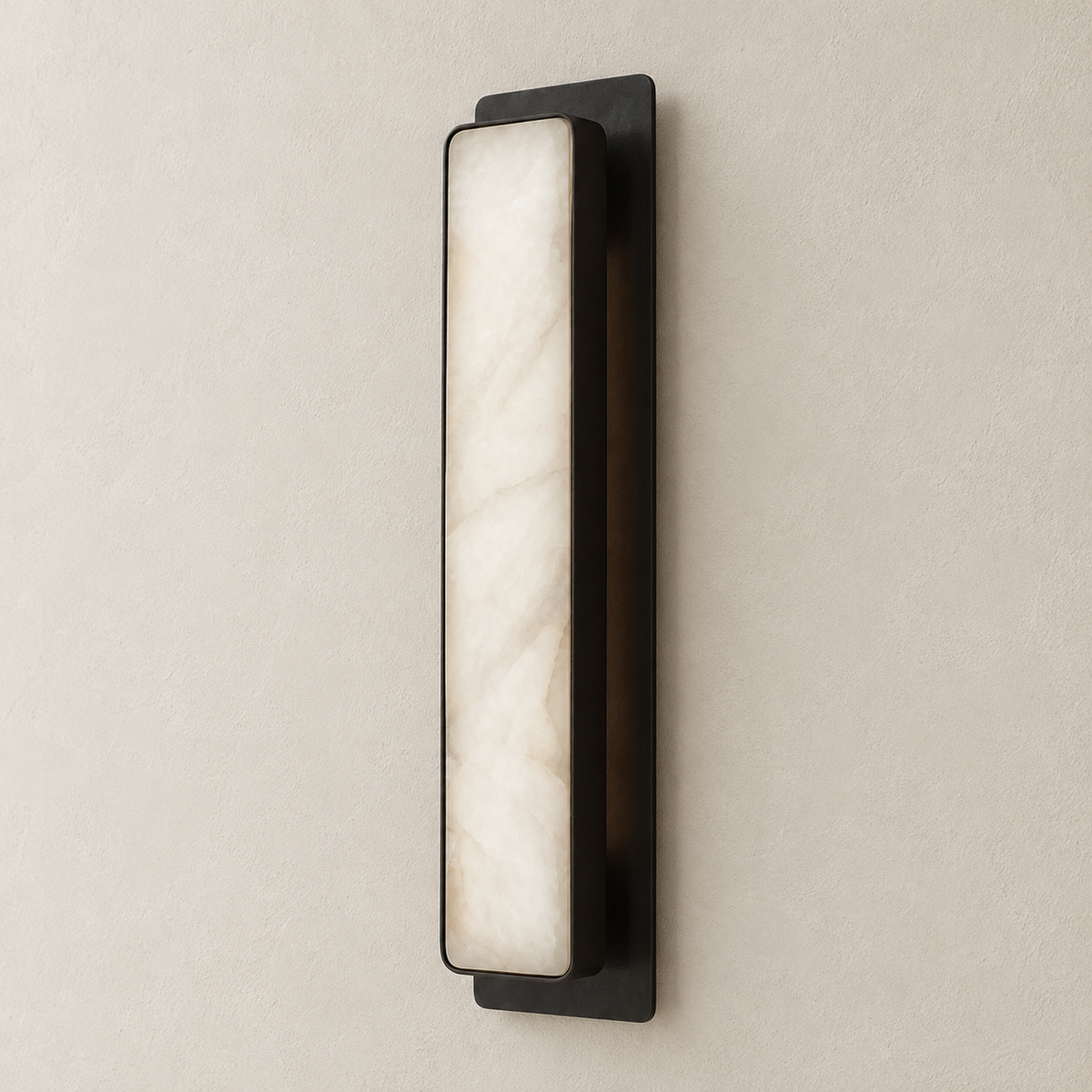 Black Mont alabaster wall sconce switched off on a beige wall.