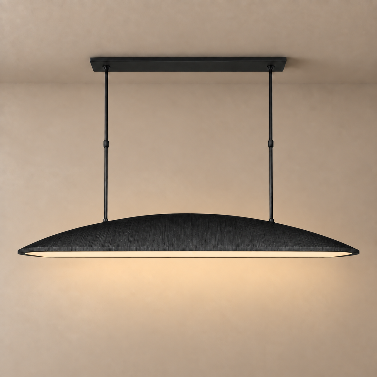 Black oval linear chandelier lit, with light falling straight down.