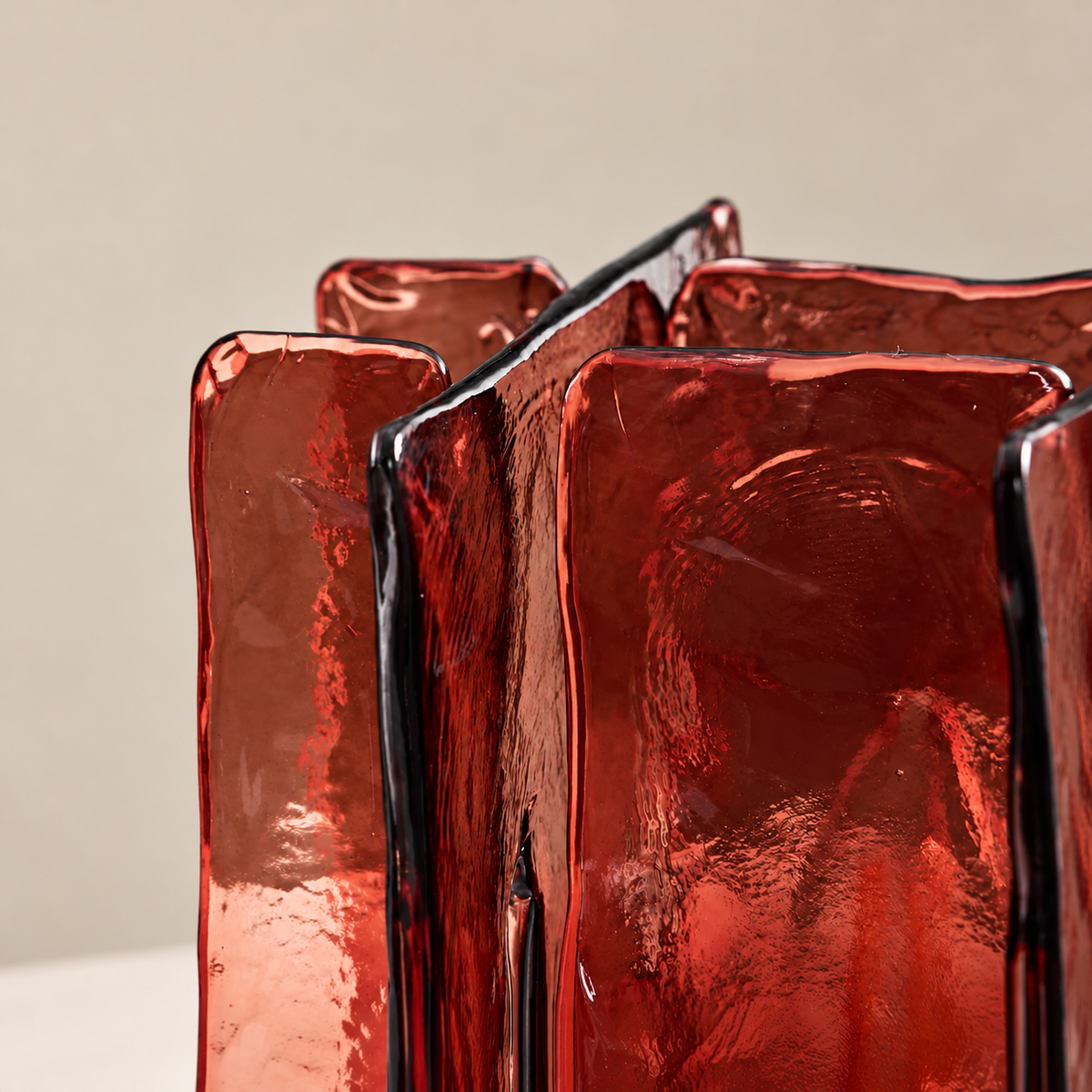 Close-up of the Blades table lamp's textured burgundy glass panels.