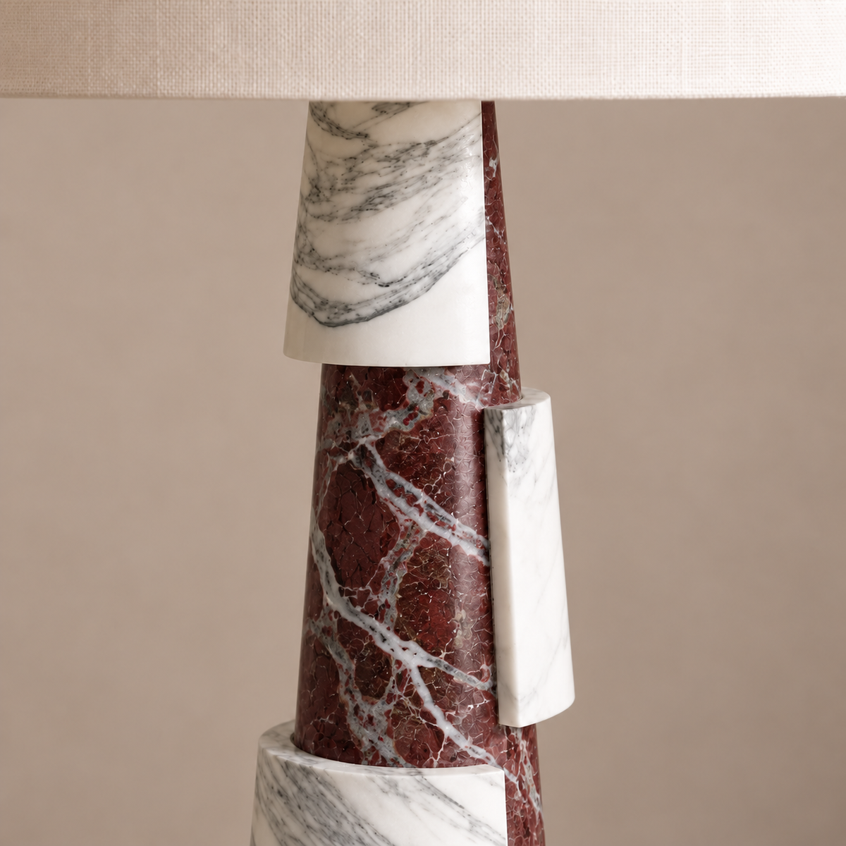 Detail of burgundy and white veined marble in the asymmetric tiered lamp base.