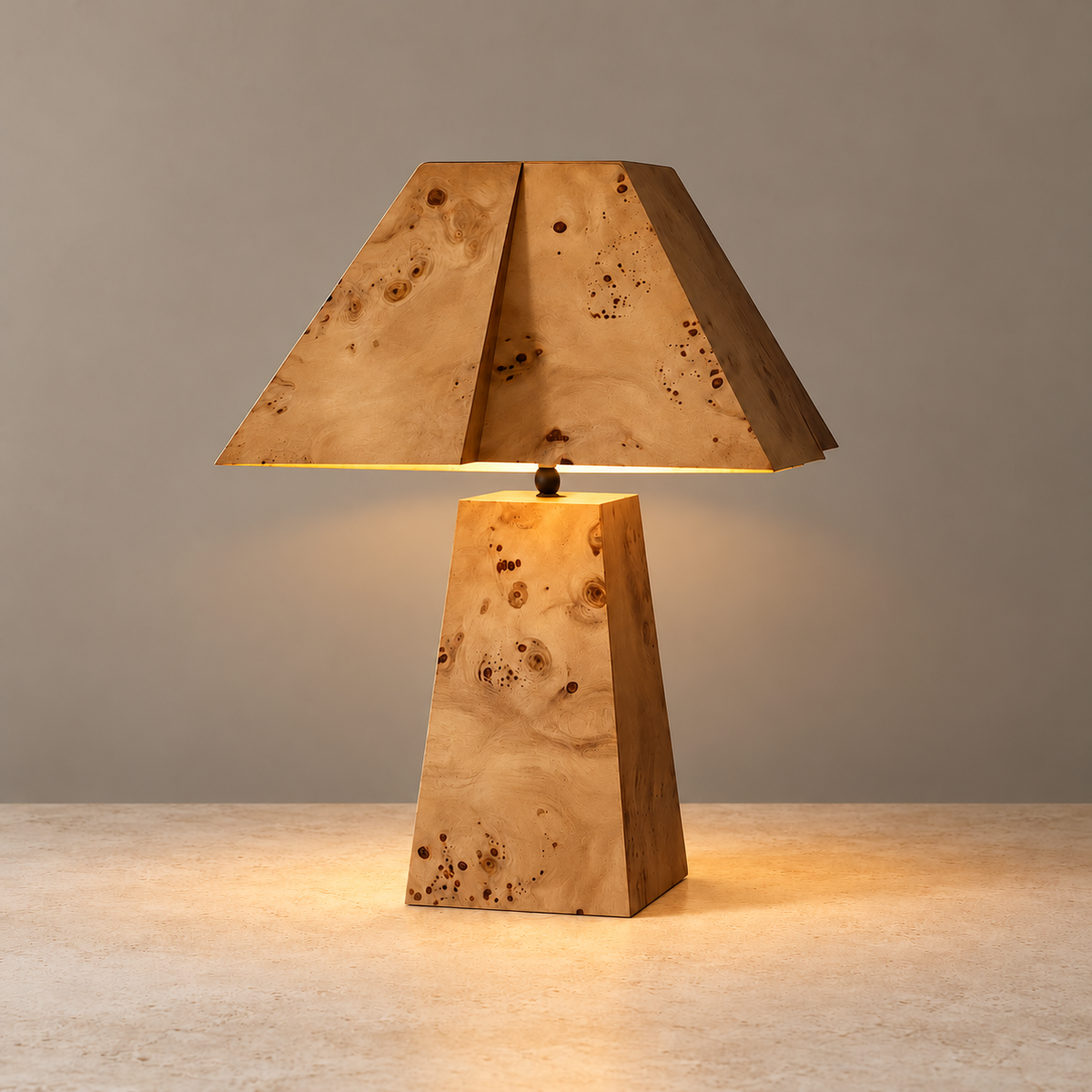 Burl wood lamp illuminated beneath its angular shade.