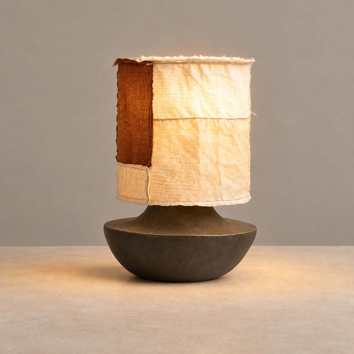 Ceramic & Silk Table Lamp, illuminated, on a neutral beige background.