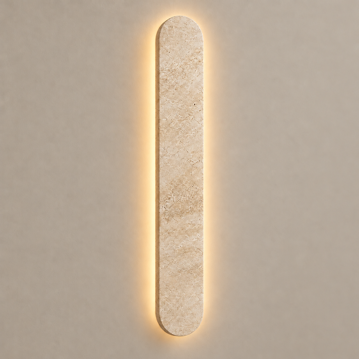 60 cm travertine wall light with a soft halo of light on the wall behind it.