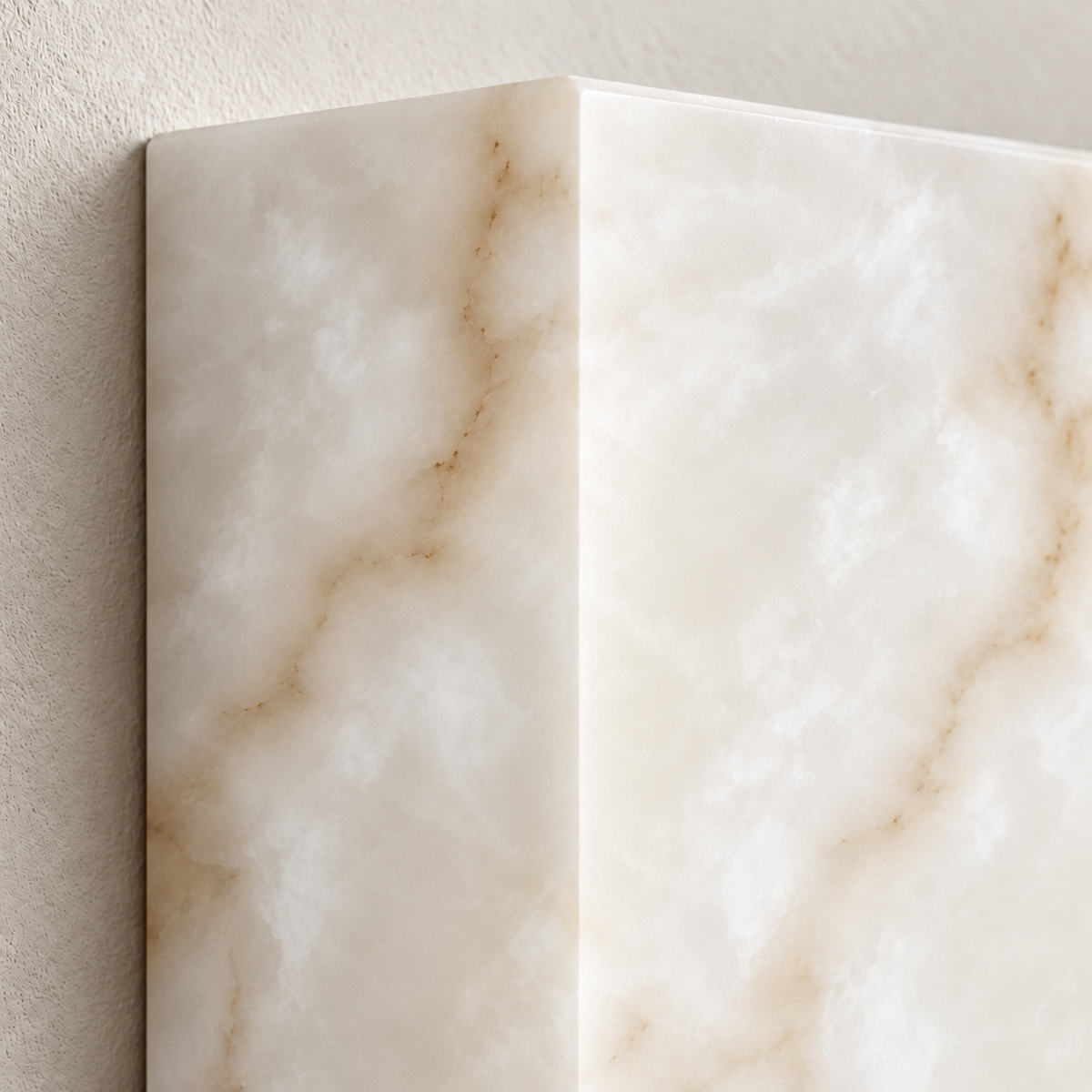 Close-up of the CLAW025 alabaster wall lamp showing its smooth corner and cloudy mineral layers.