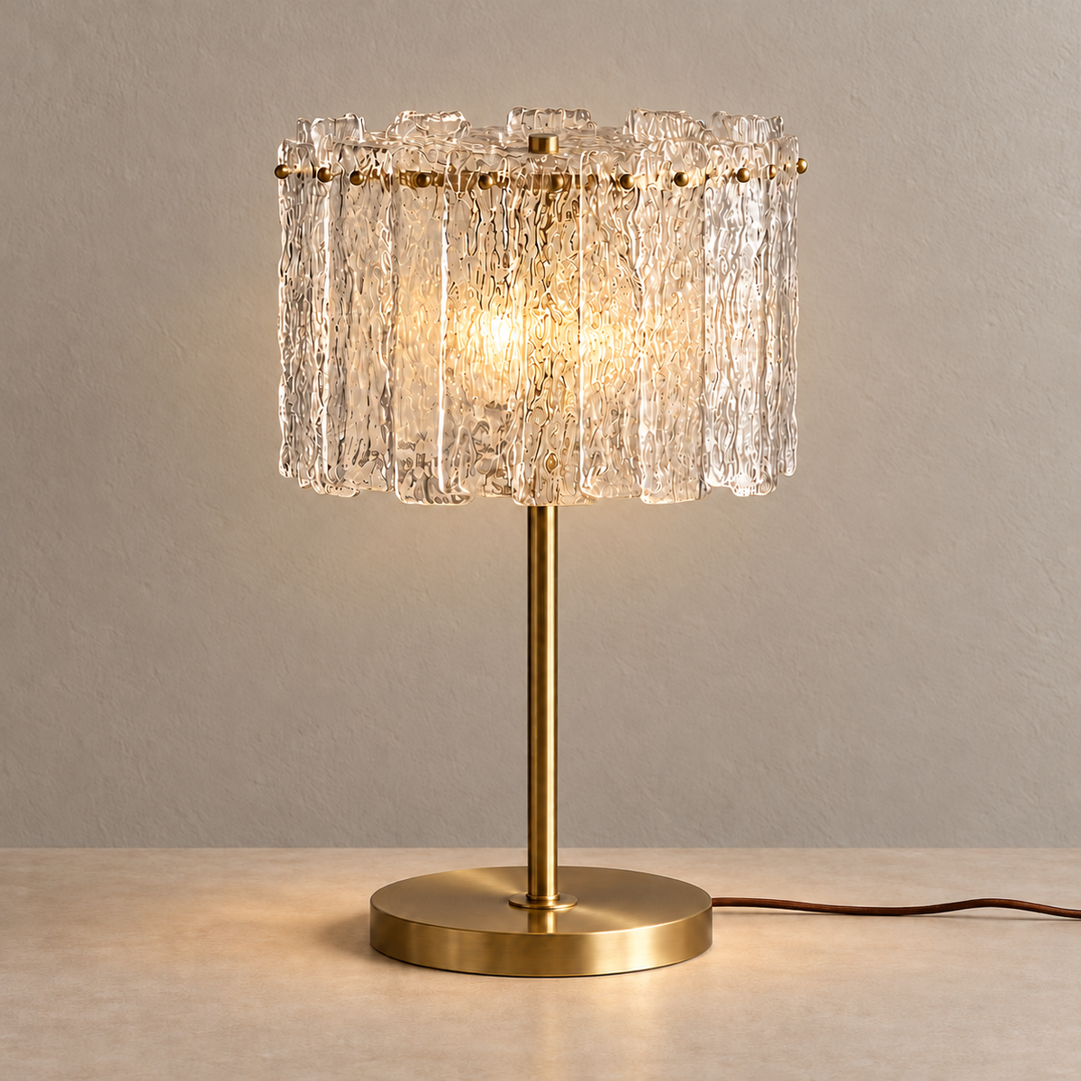 CLAZS99S brass table lamp illuminated through its clear textured glass shade.