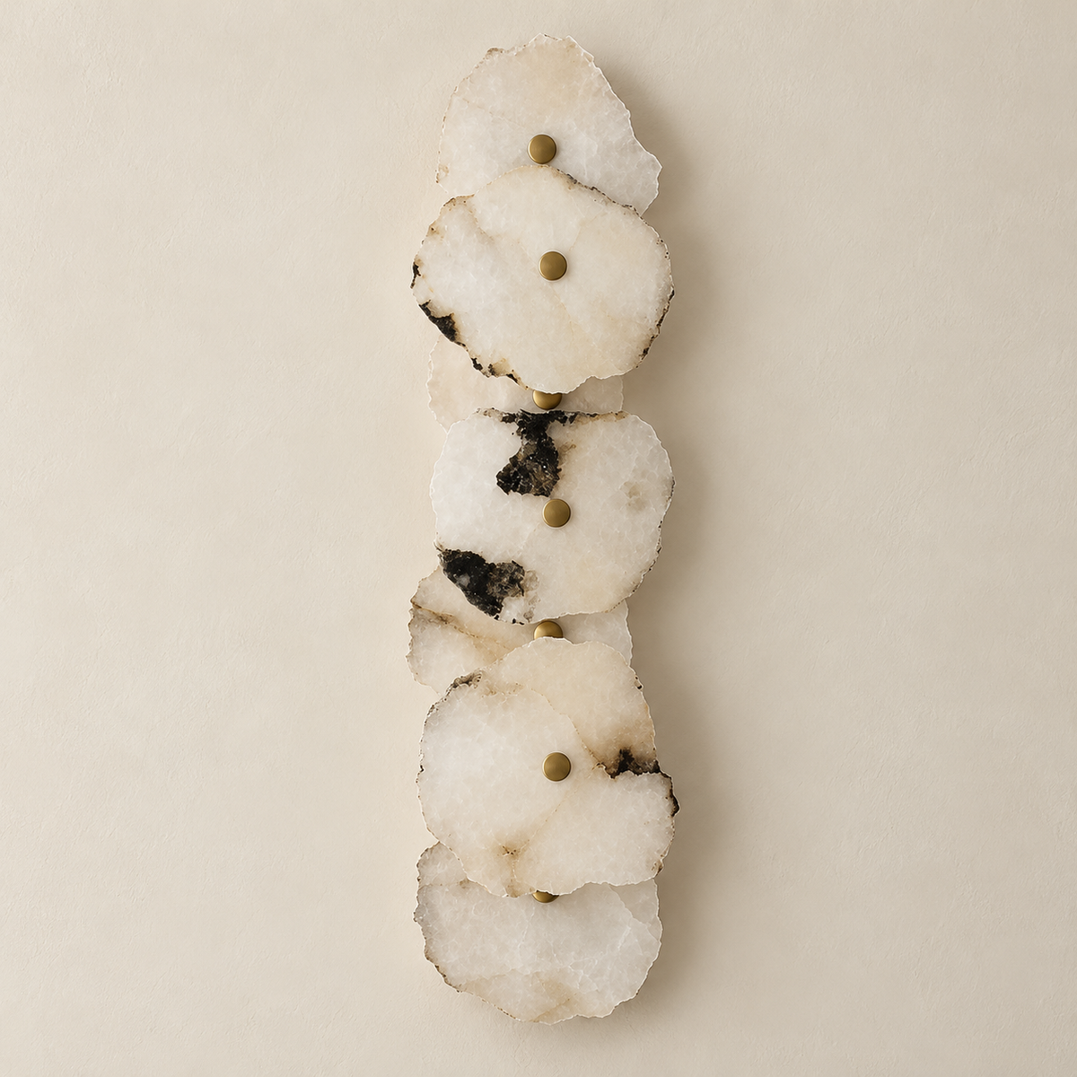 Unlit 7-stone marble wall sconce with irregular layered panels and brass retaining caps.