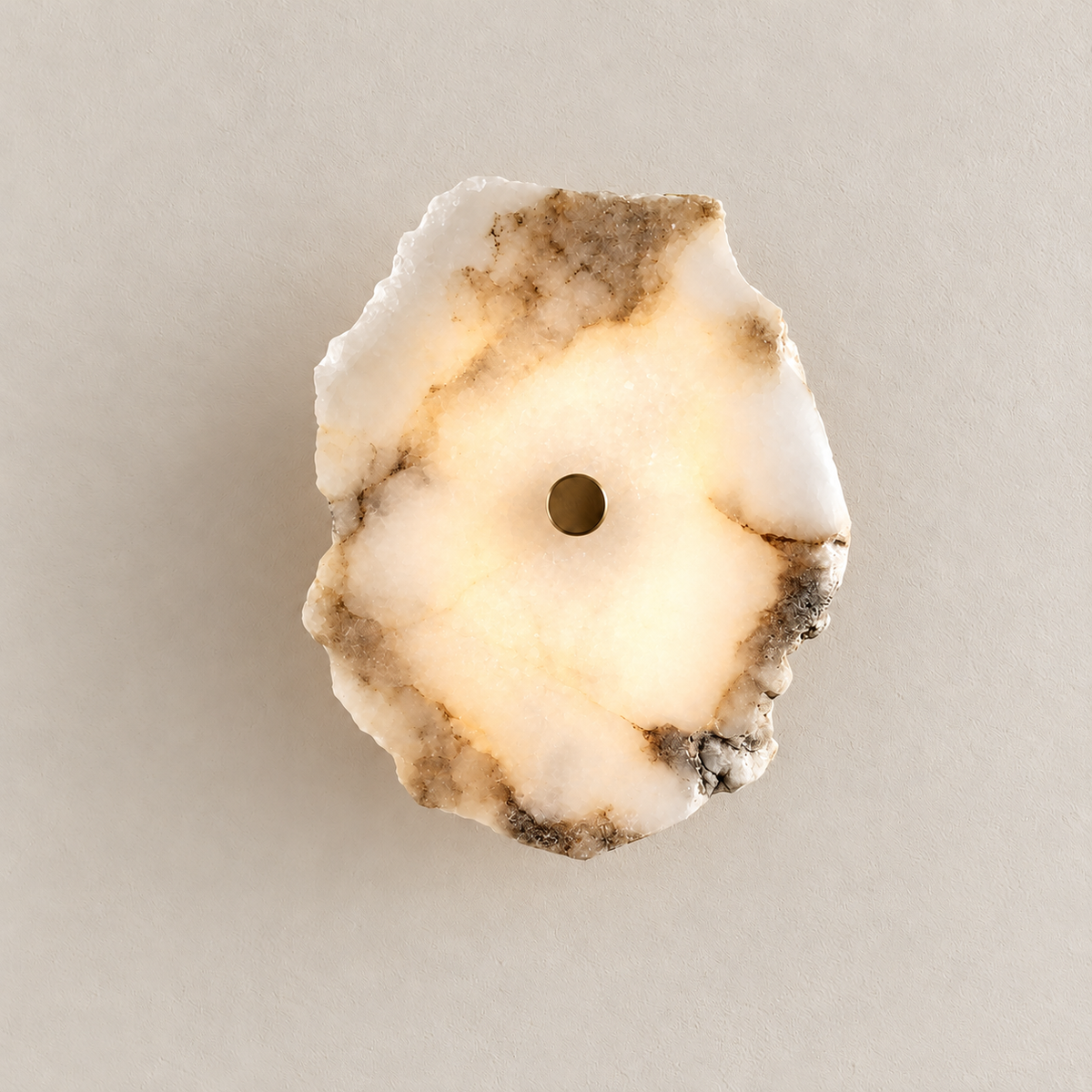 Single natural marble wall sconce illuminated with warm light behind its irregular stone panel.