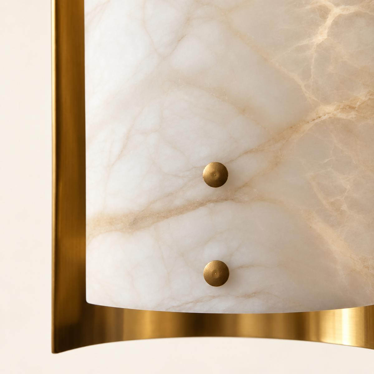 Natural alabaster veining and two brass fastening pins on a CLDVY73 chandelier shade, shown against warm ivory.