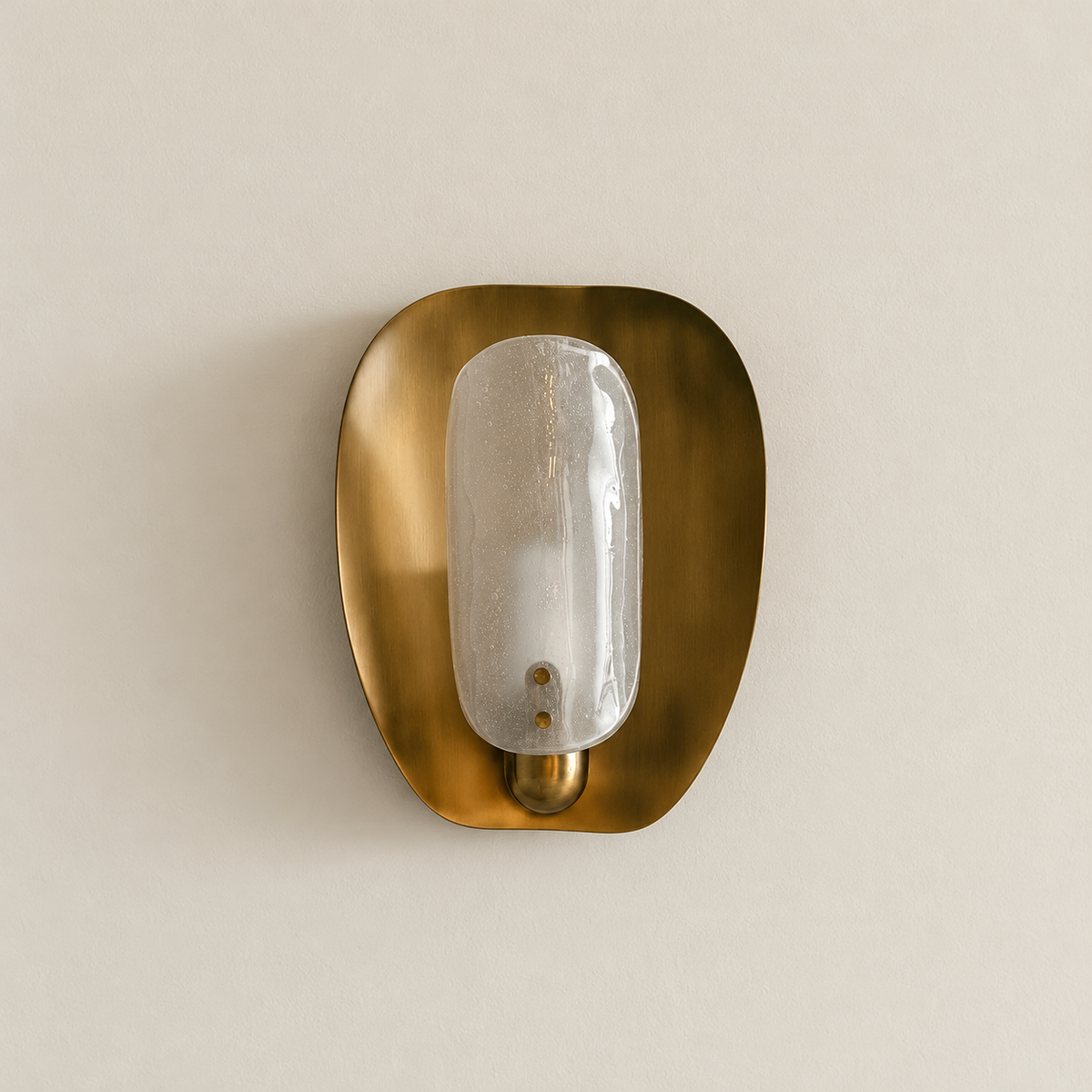 Unlit CLDW56 brass wall sconce with bubbled glass capsule on warm ivory.