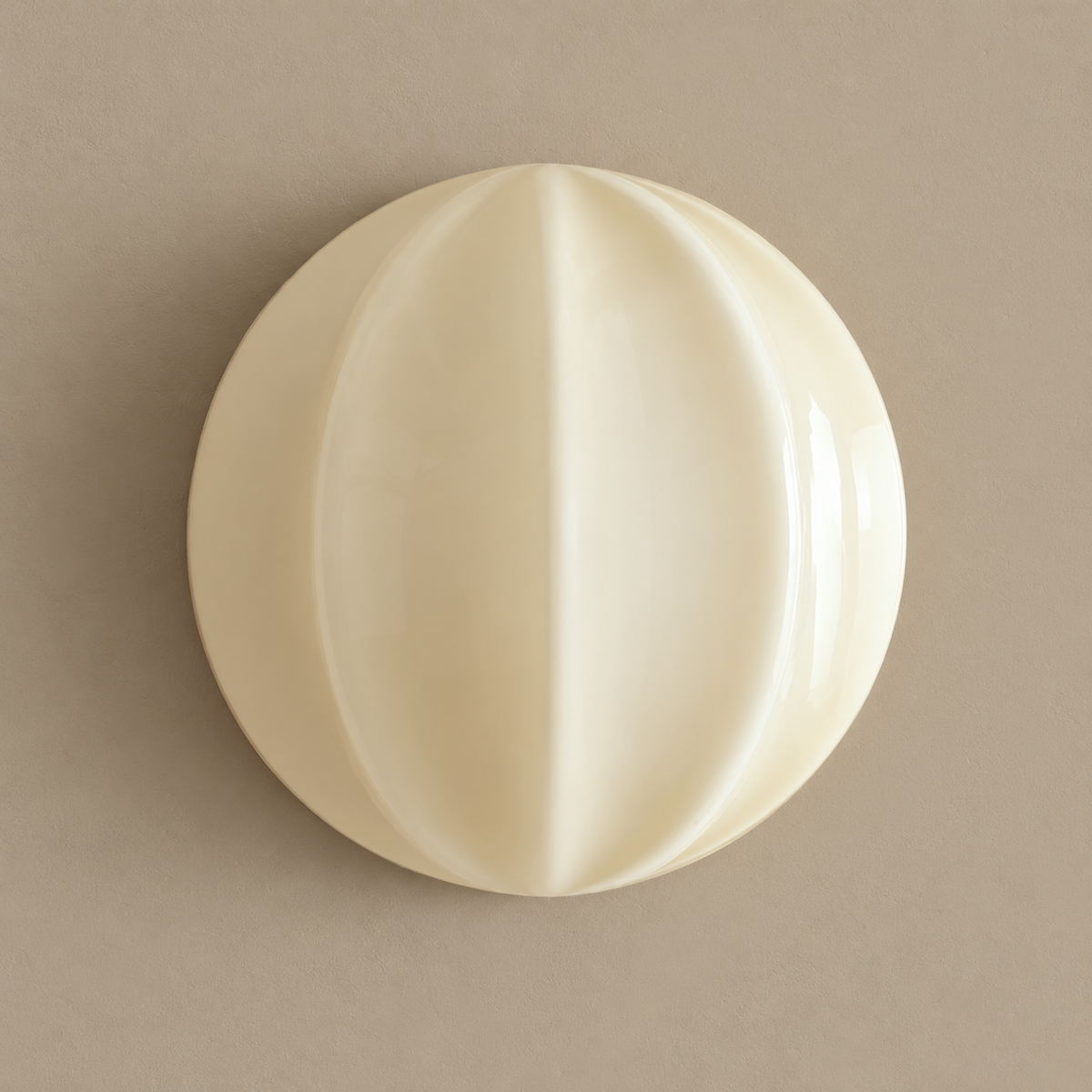 Fede ribbed cream glass and brass wall sconce, unlit on a stone-beige wall