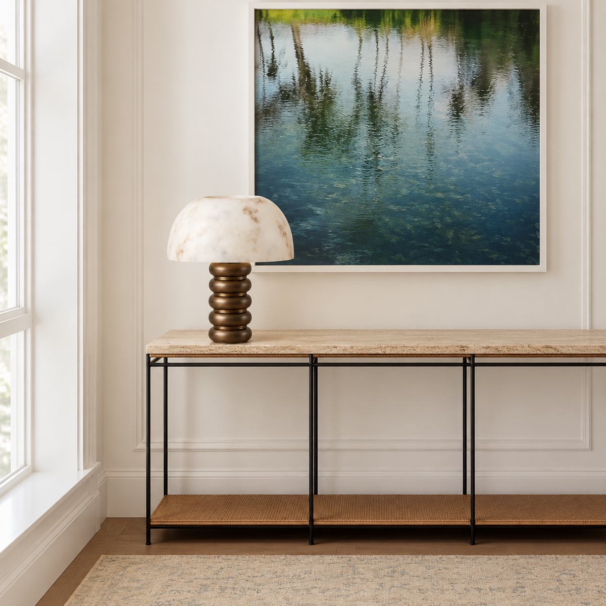 Alabaster dome table lamp on a stone console in a daylight entryway.