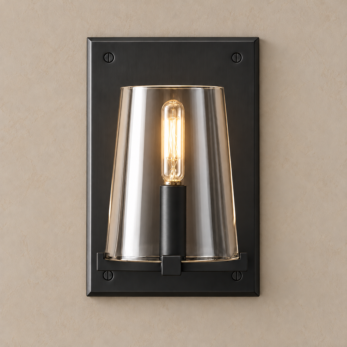 Black stainless steel and clear glass wall sconce lit, the tubular filament bulb glowing.