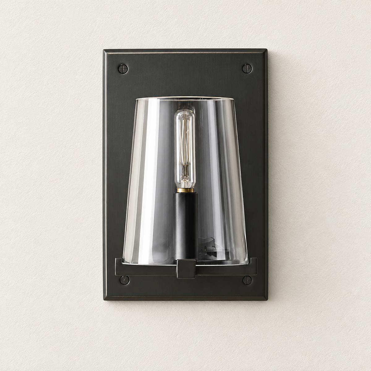 Black frame wall sconce with tapered clear glass shade, switched off.