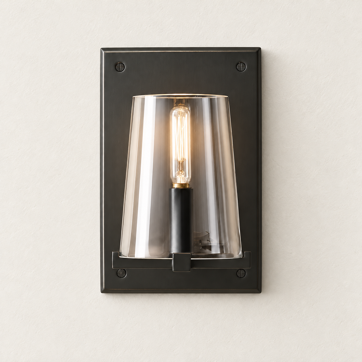 Black glass-shade sconce with its filament bulb illuminated.