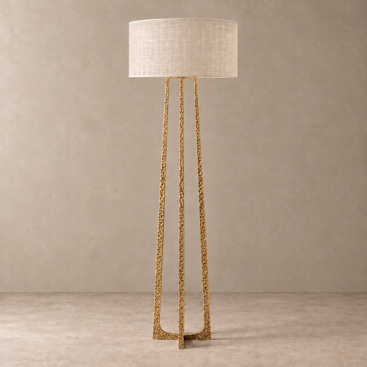 hammered brass floor lamp unlit with a single-layer silk abaca drum shade